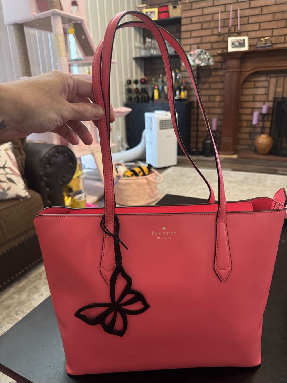 kate spade coral-pink tote with butterfly charm
